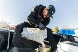 An OBEX technician pouring granule to protect lawns and landscaping 4 An OBEX technician pouring granule to protect lawns and landscaping
