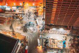 A nighttime view of a construction site showing how urbanization and city pests increase with expanding development.